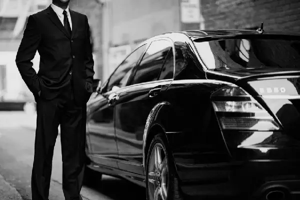 Executive chauffeur with luxury vehicle